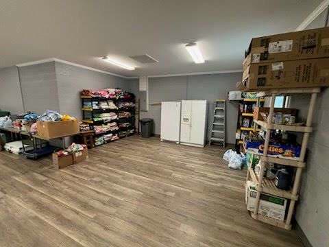 Shelving units and boxes at Post 206 stocked with canned goods and household supplies for the Post's food distribution