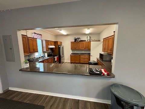 A serving pass-through window between the Post 206 event room and its kitchen, with a dark countertop ledge
